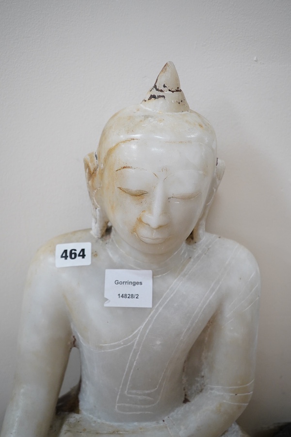 An 18th century Burmese marble Buddha, 57cm high. Condition - commensurate with age